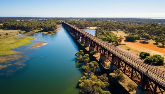 Foto un tren está cruzando un puente sobre un río