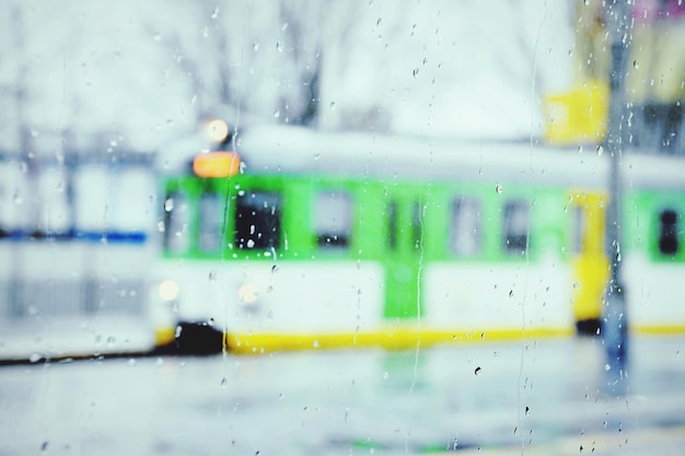 Foto el tren en la estación visto desde una ventana húmeda