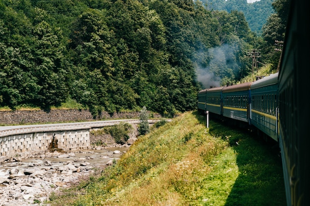 Tren a lo largo del río en día soleado