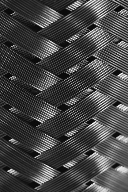 Trenzado de alambre de metal en macro. Textura de acero detallada de cerca. Fondo de metal ideal con espacio de copia. Plantilla brillante.