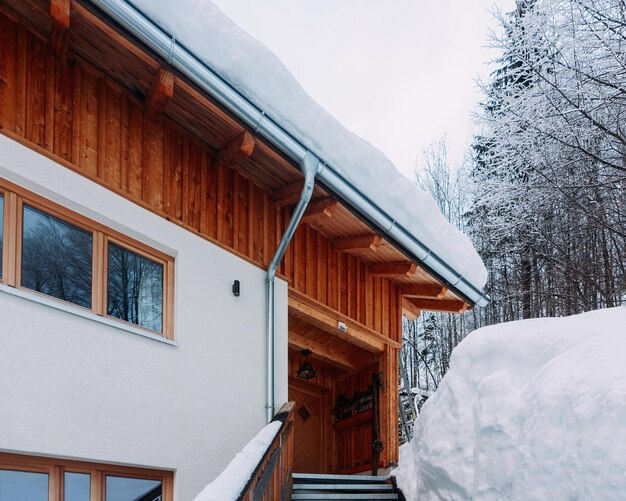 Treppenhaus in Hausarchitektur und verschneite Winterlandschaft im Dorf Bad Goisern bei Hallstatt in Oberösterreich. Reihenhausimmobilien und Wohngebäude.