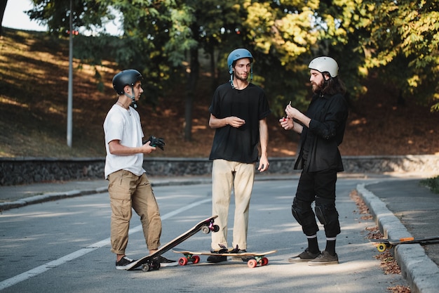 Três caras falam sobre skate. Foto de alta qualidade