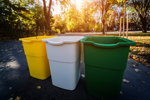 Tres contenedores de basura en diferentes colores.