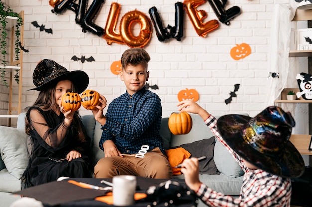 três crianças em uma festa de halloween