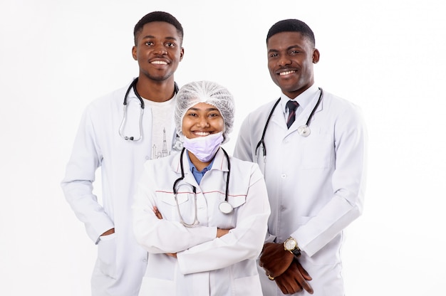 Tres doctores en un blanco. Mujer india con un estetoscopio. Hombres africanos