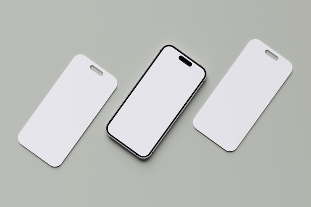 tres iPhones blancos están sobre una superficie gris