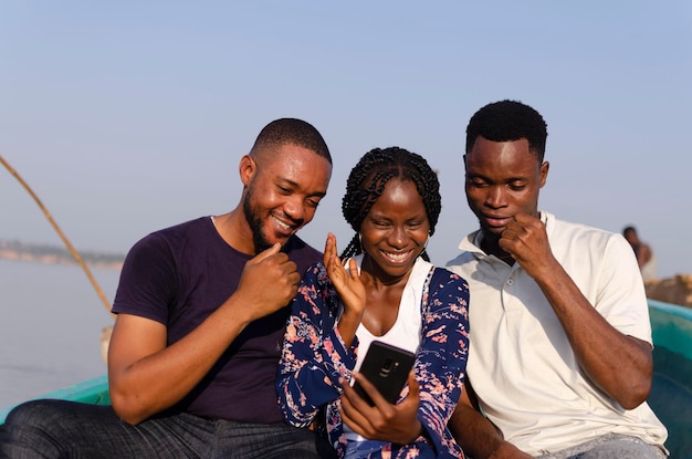 Tres jóvenes amigos africanos emocionados por lo que vieron en su celular