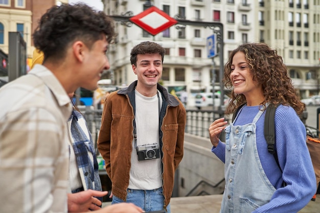 Três pessoas conversando em uma rua com uma câmera acoplada ao pulso