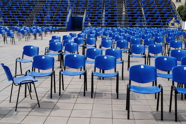 Tribuna lotada em evento de massa com cadeiras dispostas levando em consideração a distância social