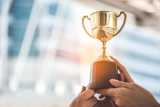 Troféu de ouro do campeão para o vencedor fundo conceito de sucesso e realização tema de prêmio de esporte e taça