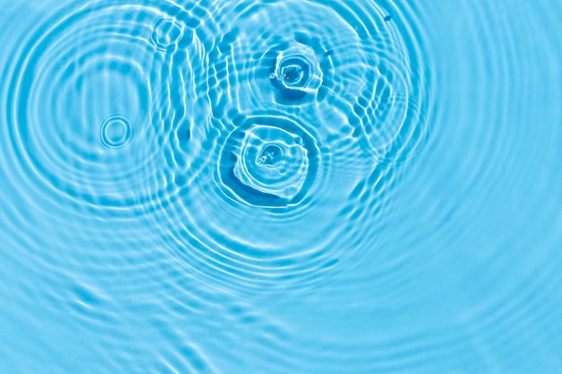 Tropfen und Glühbirnen auf blauem Wasser unter Sonnenlicht Draufsicht flach gelegt