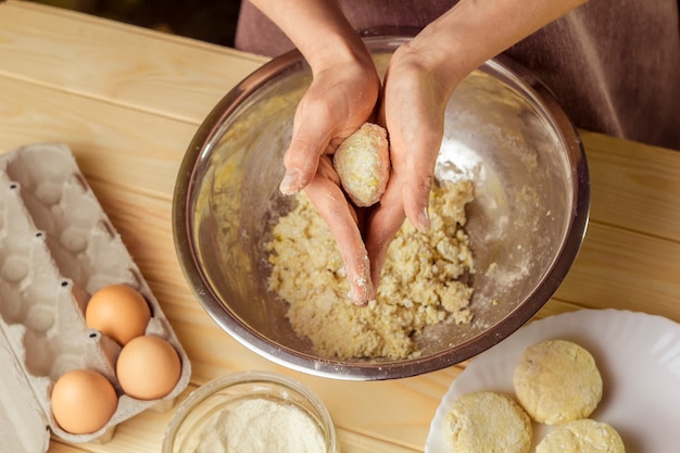 Trozos de masa en las manos del cocinero.