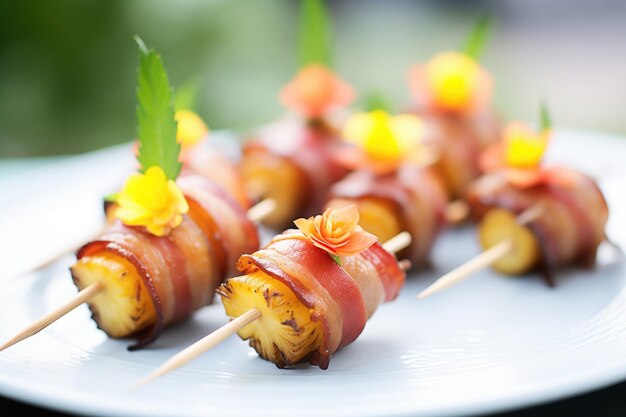 Foto trozos de piña envueltos en tocino en un plato con tema tropical