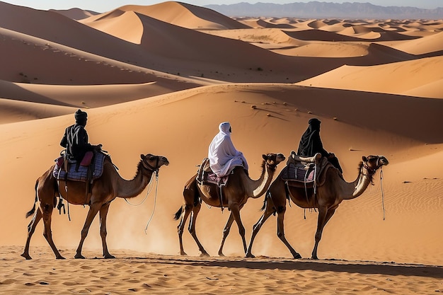 Foto tuareg com camelos caminham pelo deserto na parte ocidental do deserto do saara, em marrocos