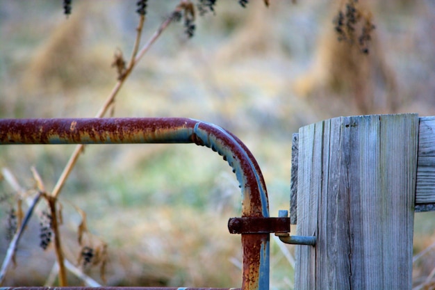 Una tubería oxidada fijada a una tabla de madera