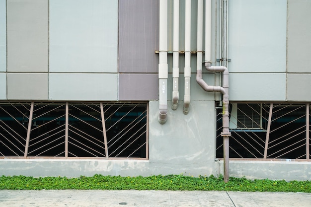 Tubos em uma parede de concreto grunge. Linhas de tubos de conduíte em uma parede velha com espaço de cópia. Foco seletivo