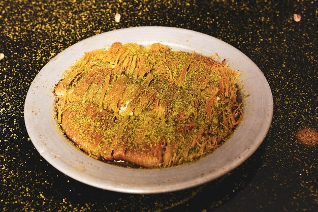 Türkisches Dessert Kunefe Kunafa Kadayif mit Pistazienpulver und Käse heiß gegessen eine Süßigkeit