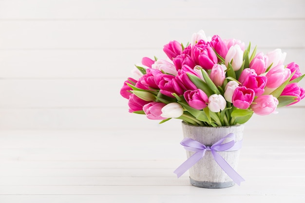 Tulipán rosa en la tarjeta de felicitación blanca de Pascua y primavera.
