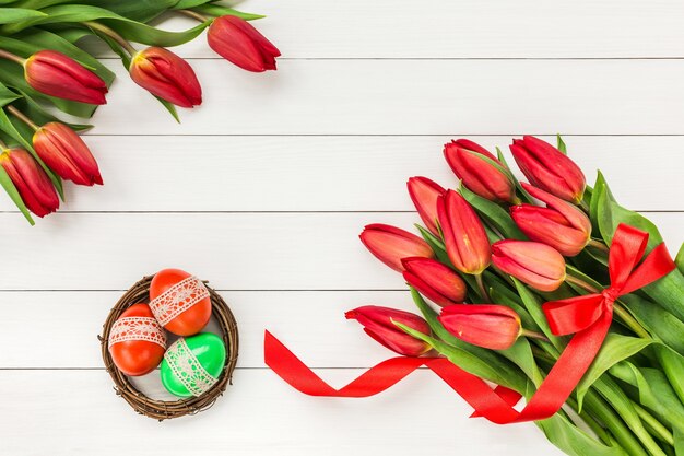 Tulipanes rojos y huevos de Pascua.