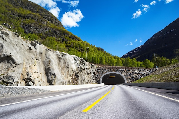 Túnel en las montañas de Noruega contra el cielo azul