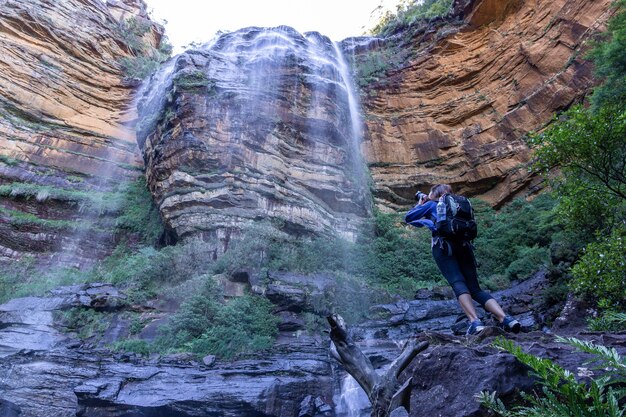 Turismo feminino com mochila tirar foto na cachoeira de Wentworth Falls