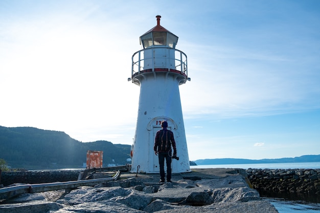 Turista hombre con pie de gran faro