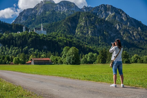 Turista tomando fotos del castillo de Neuschwanstein Alpes bávaros Alemania