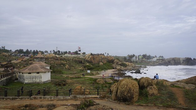 Foto turistas apreciando a bela paisagem cênica da praia de muttompoluído com lixo