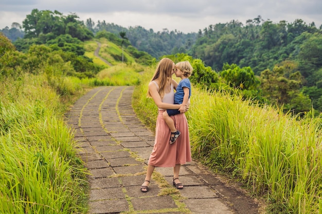 Turistas de mãe e filho em Campuhan Ridge Walk, Scenic Green Valley em Ubud Bali. Viajando com o conceito de crianças.