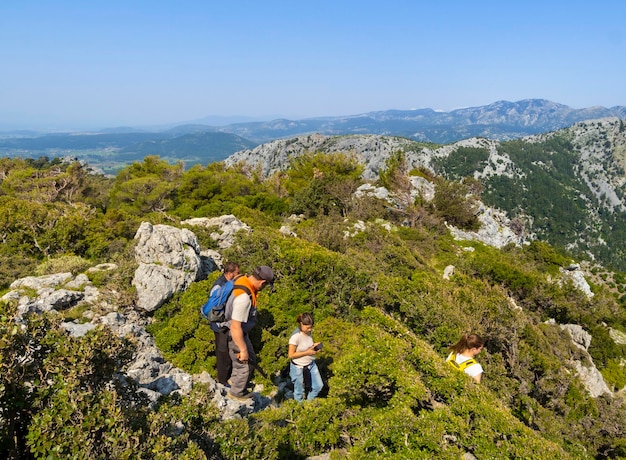 Los turistas suben las montañas en una ruta de senderismo en el bosque en las montañas de Dirfys en Grecia