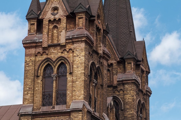 Turmfragment der römisch-katholischen Kirche mit blauem Himmel und weißen Wolken im Hintergrund