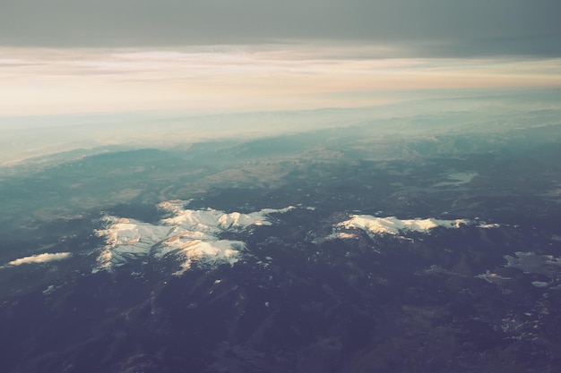 Turquía Ankara Vista desde la ventana del avión a los lagos de las montañas turcas y picos nevados Nubes en capas y horizonte Lagos Saryar Nallihan y Camlidere Salida desde el aeropuerto de Esenboga Havalimani