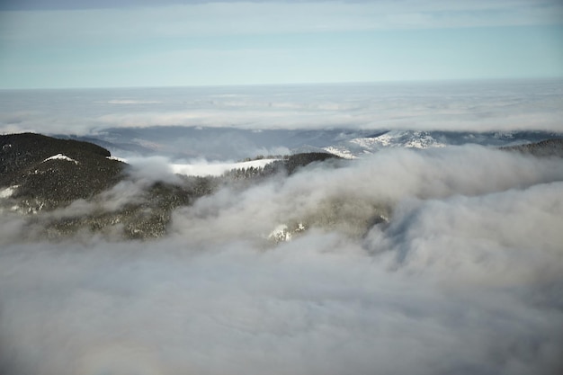 Foto Über dem nebelmeer in den winterbergen sonniger tag in den schneebedeckten karpaten wolken über dem klaren himmel