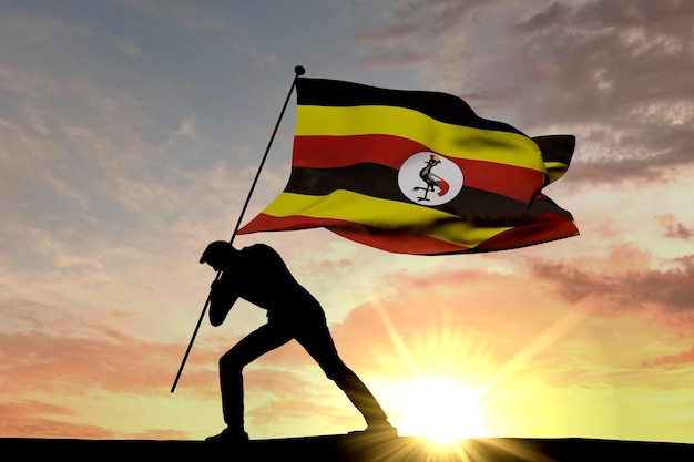 Uganda-Flagge wird von einer männlichen Silhouette 3D-Rendering in den Boden gedrückt