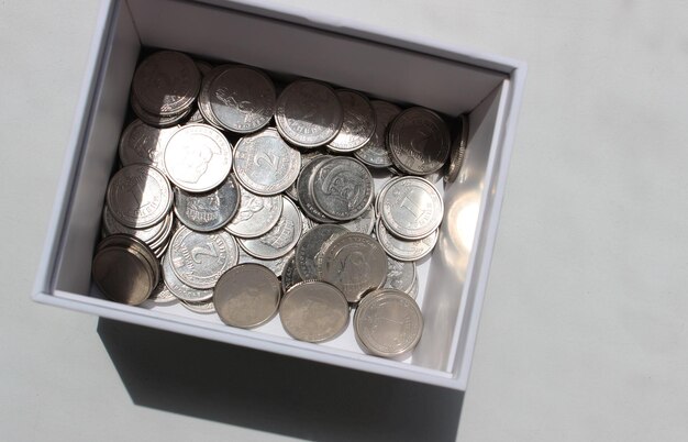 Ukrainische Münzen im Wert von 1 und 2 Hrywnia in einem Kartonkasten Studio isoliertes Stockfoto