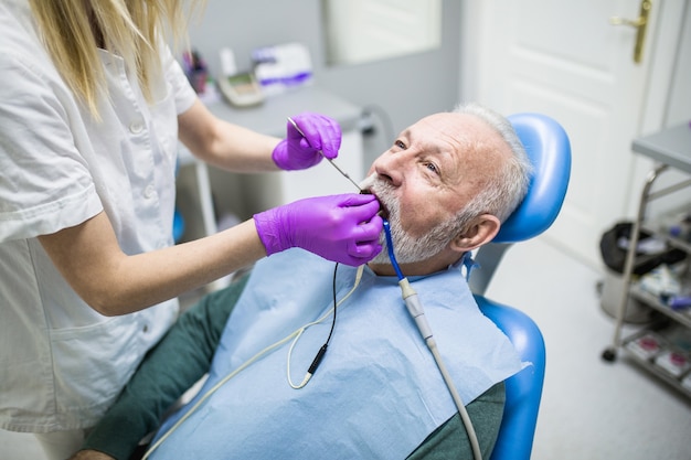 Último homem tendo tratamento dentário no consultório do dentista.