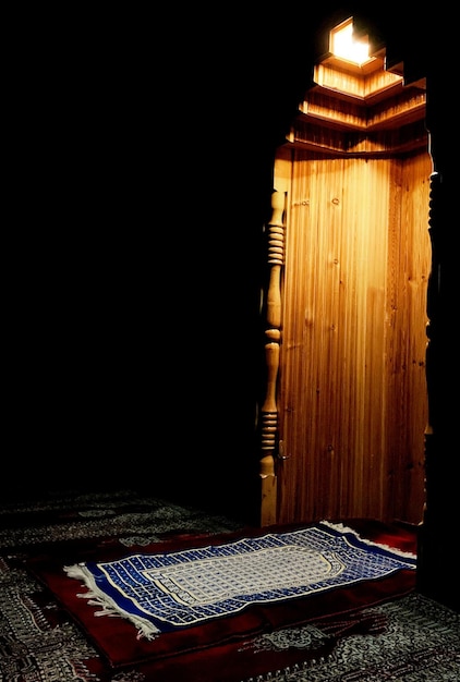 Um armário de madeira com um padrão azul fica no escuro.