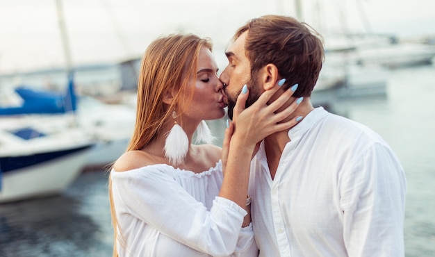 Um casal apaixonado a beijar-se no clube de iates. Conceito de amor romântico.