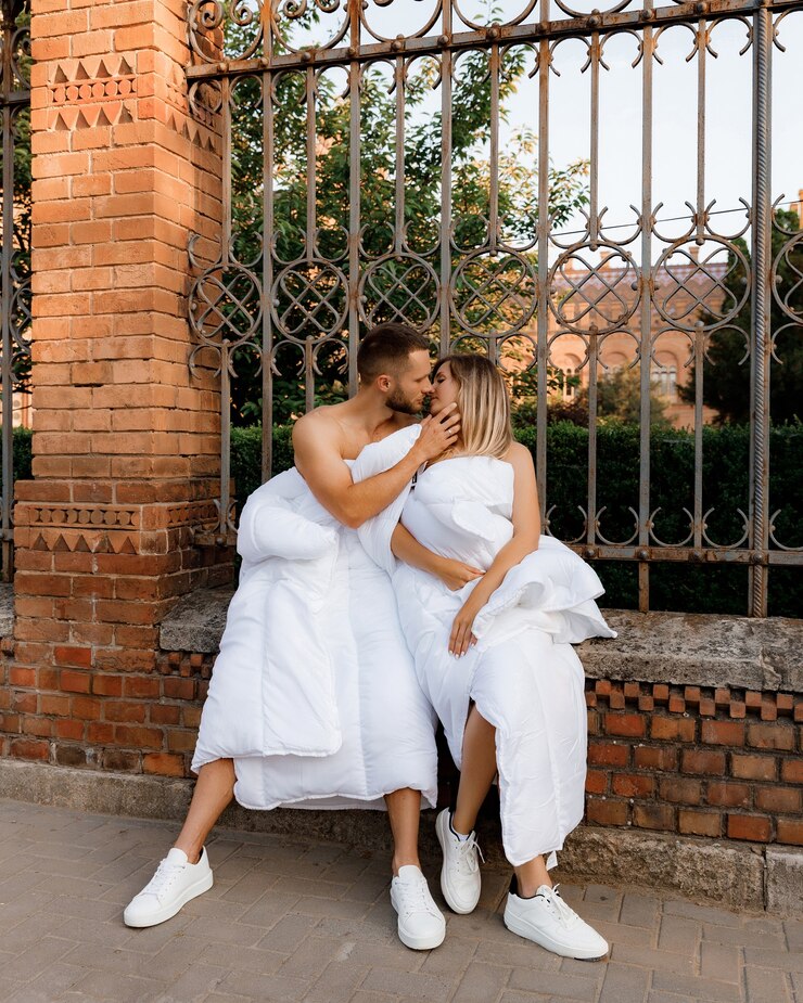 Um casal em cobertores andando pela cidade