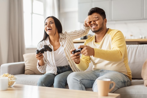 Um casal feliz jogando videogames juntos em casa