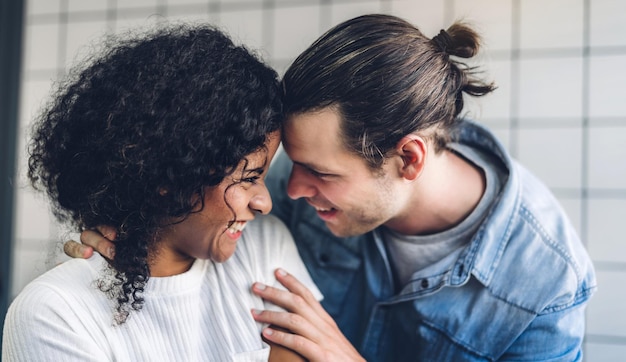 Um casal romântico a sorrir em casa.