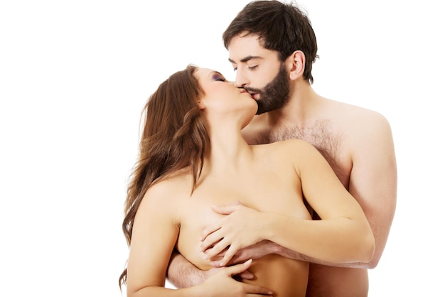 Foto um casal romântico sem camisa a beijar-se contra um fundo branco