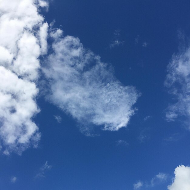 Um céu azul com nuvens e um dragão nele.