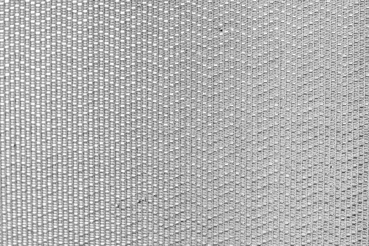 Foto um close-up de um fundo cinzento com um padrão de pontos e um diamante