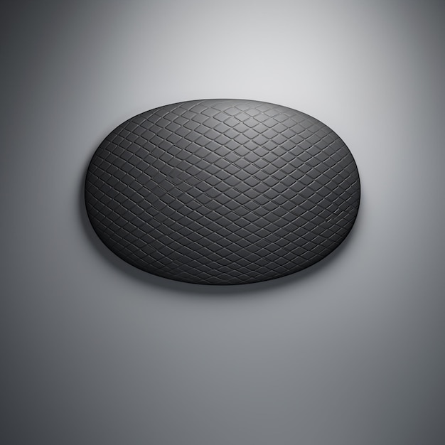 um close-up de um objeto circular preto em uma superfície cinzenta