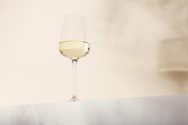 Foto um copo de vinho branco está sobre a mesa fundo claro