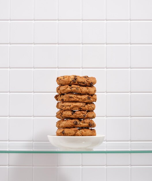 Um delicioso biscoito saudável com pedaços de chocolate está em um pequeno prato branco