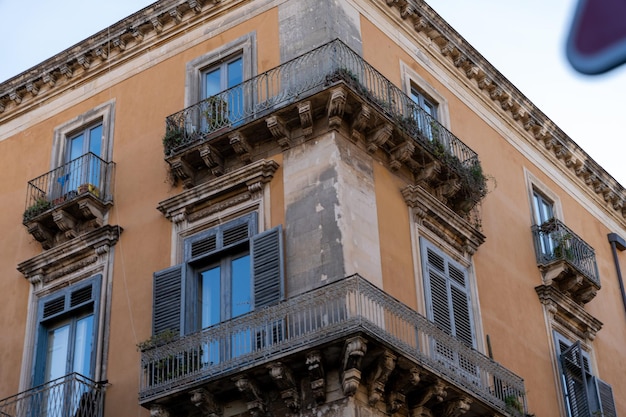 Um edifício com uma varanda tem muitas janelas