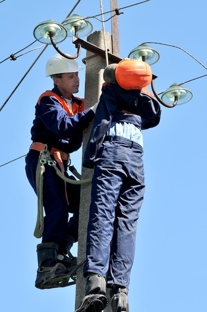 Um eletricista ajuda o trabalhador afetado por um choque elétrico. Treinamento em um manequim.