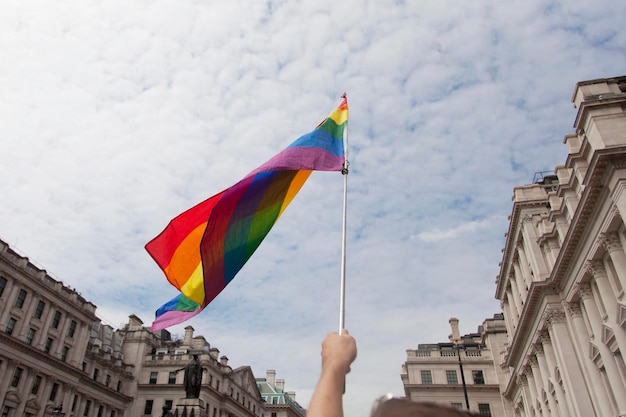 Um espectador agita uma bandeira de arco-íris gay em uma marcha do orgulho gay LGBT em Londres